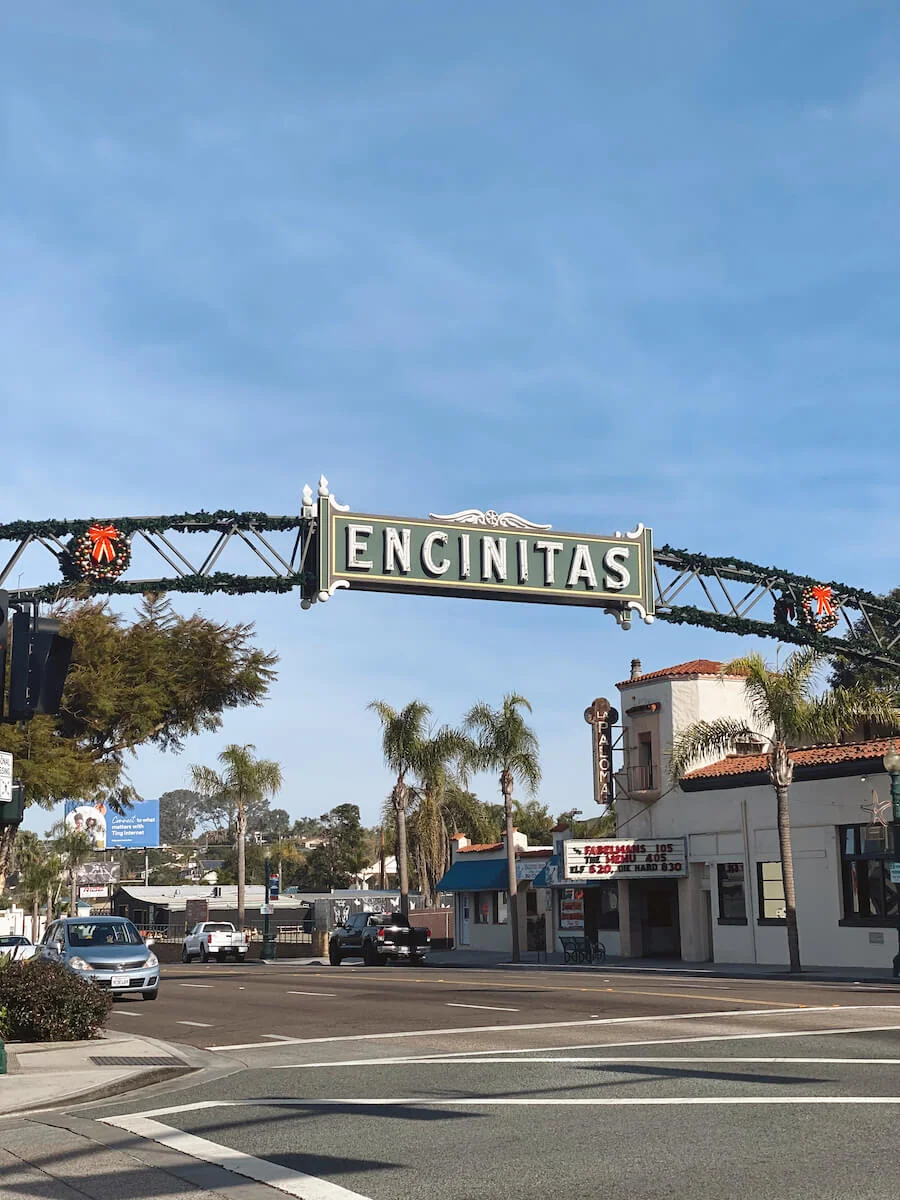 Driving under the iconic Encinitas sign on Highway 101.